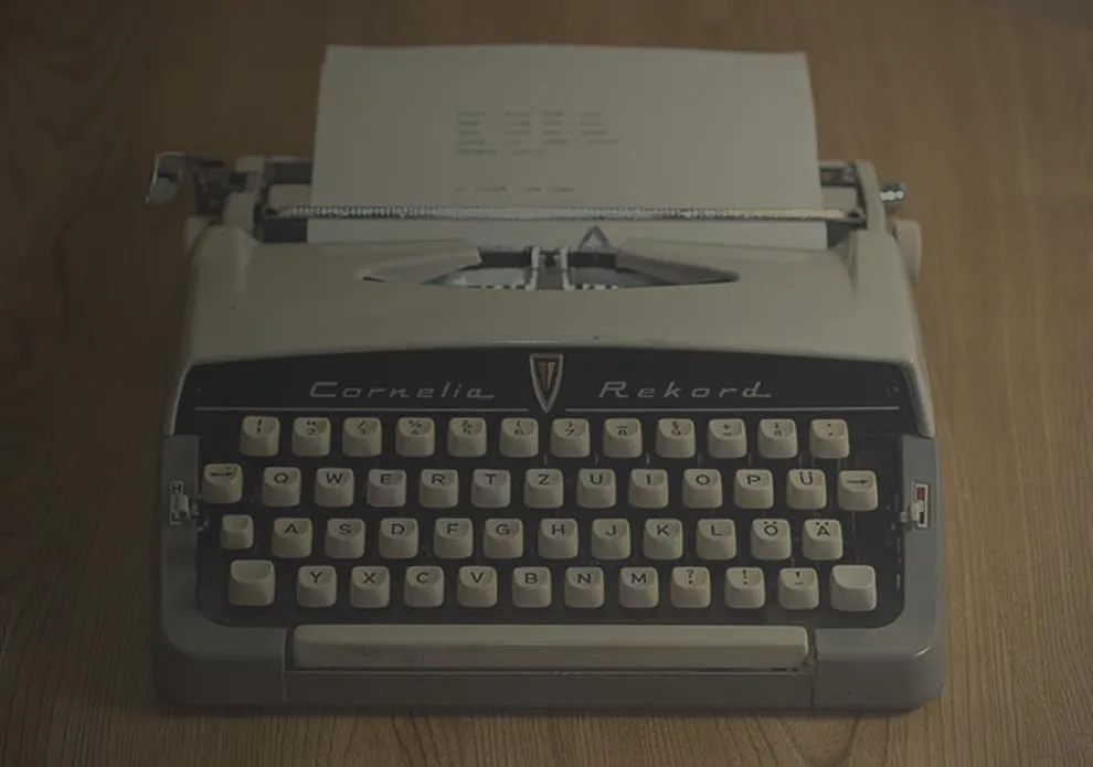 A person's hands typing on a laptop keyboard.